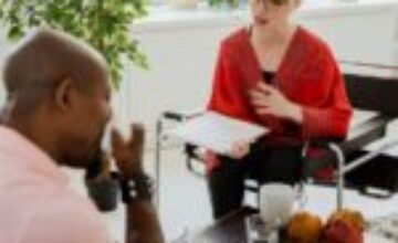 A client and therapist having a calm conversation in a modern office