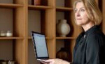 Midlife woman using a laptop while sitting at home