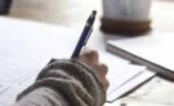 A calm, structured study workspace with a laptop and planner for executive function support.