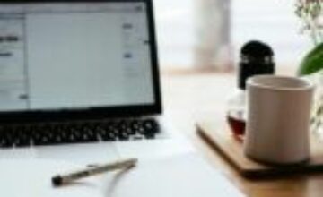 Open notebook and laptop on a desk, representing a task that is waiting to be started