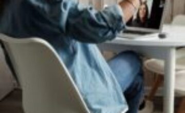 Adult sitting with a laptop in a quiet home setting