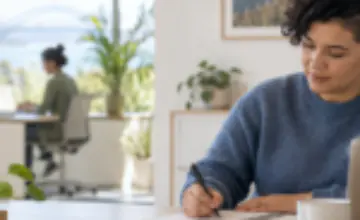 Professional writing a priority list at a desk in a calm office.